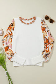 White knit sweater with scalloped neckline and colorful floral print puff sleeves