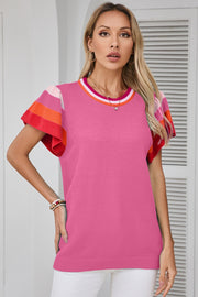 Pink knit blouse with flutter sleeves and colorblock trim on sleeves and neckline.