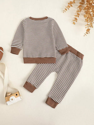 Baby striped knit set with brown trim.