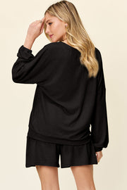 Black waffle knit lounge set with blouson sleeves and matching shorts.