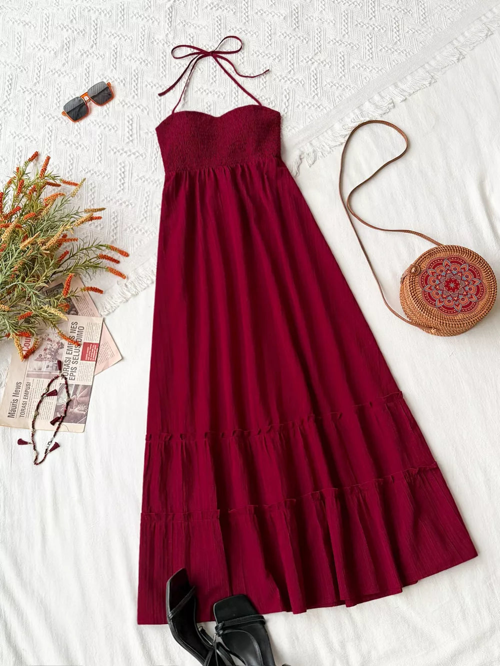 Burgundy halter neck tiered maxi dress with smocked bodice and ruffle hem.