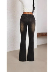 Belted high waist flare jeans in charcoal denim with distressed detailing and frayed hem.