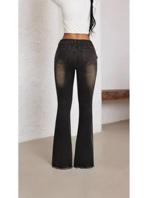 Belted high waist flare jeans in charcoal denim with distressed detailing and frayed hem.