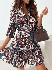 Brown floral tie-waist mini dress with button-down front and ruffled hem.