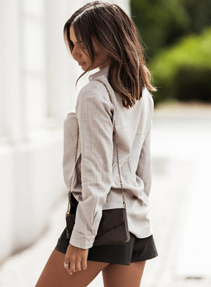 Light Gray textured cotton relaxed fit shirt with buttoned cuffs and a cinched waist detail.