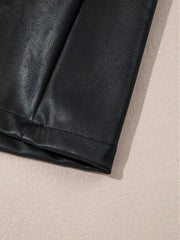 Black vegan leather sleeveless mini dress hem detail