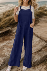 Dark blue textured cotton overalls with square pockets and wide legs
