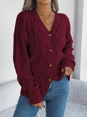 Burgundy cable knit cardigan with balloon sleeves and button front.