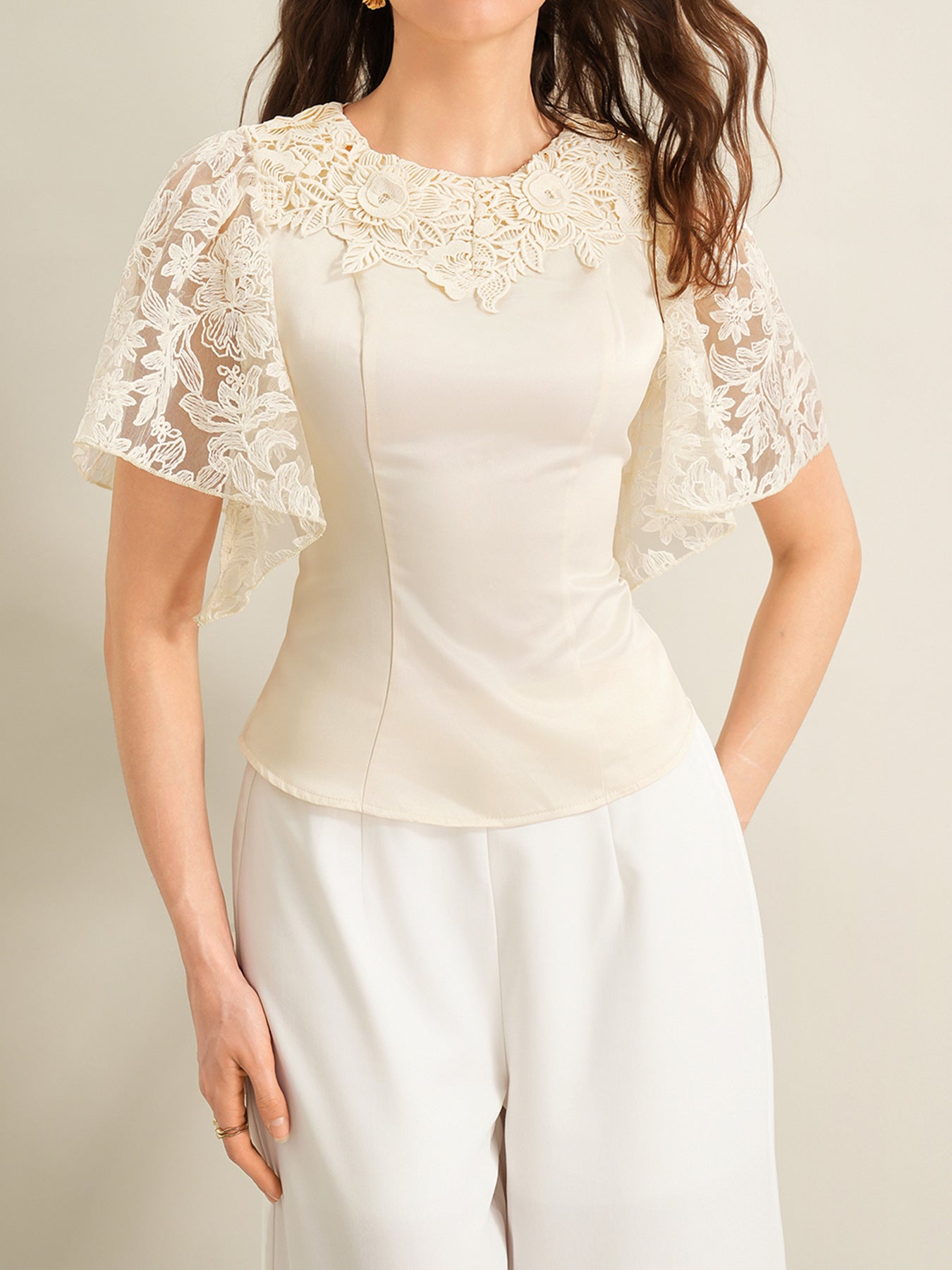 Apricot lace trimmed short sleeve blouse with floral neckline detail.