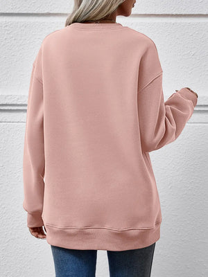 Graphic print cozy crewneck sweatshirt in Blush Pink with crew neck and long sleeves.