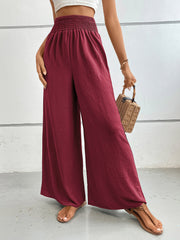 Burgundy textured palazzo lounge trousers with smocked waist and wide leg.