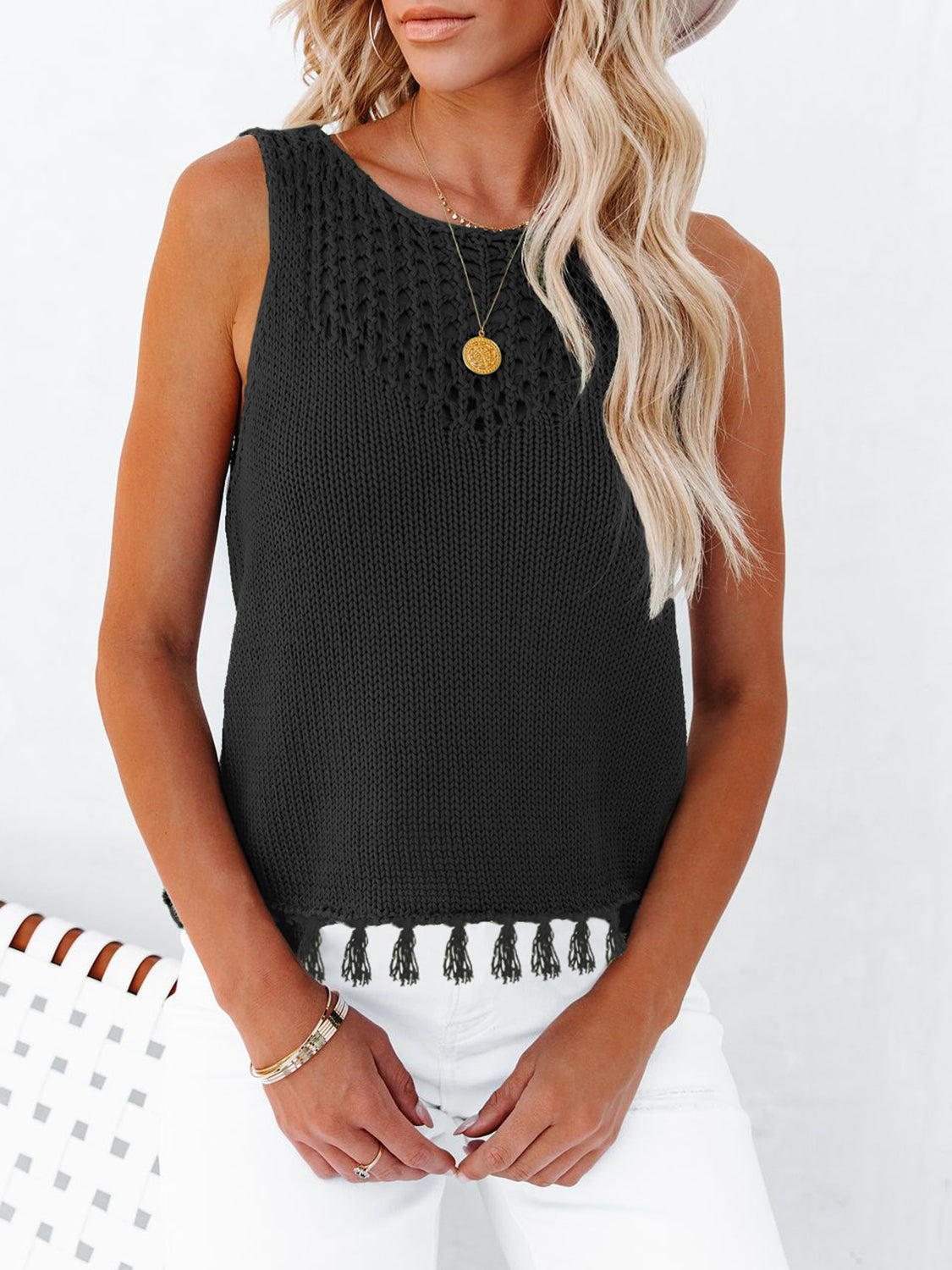 Black knit tank top with crochet detail and tassel trim