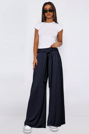 Dark Navy wide-leg flow pants with self-tie waist, styled with a white t-shirt.