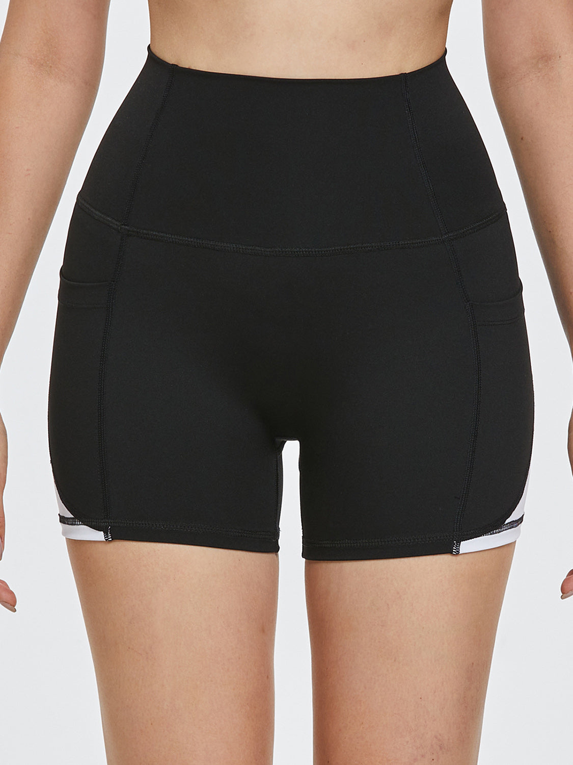 Black sculpted shorts with white side stripe detail and pockets.