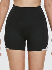 Black sculpted shorts with white side stripe detail and pockets.
