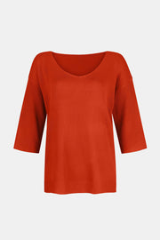 Orange V-neck knit sweater with flared 3/4 sleeves and ribbed cuffs.