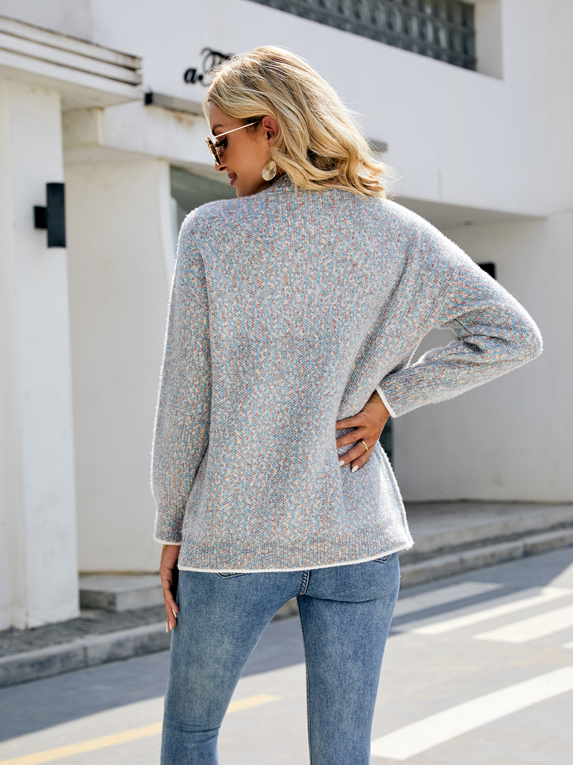 Light gray textured knit cardigan with contrast trim and buttoned front.