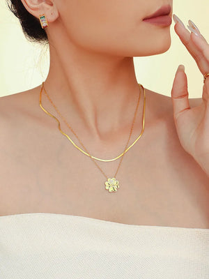 Gold layered necklace with flat chain and clover charm with small stones