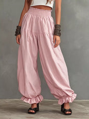 Full Size Smocked Ruffle Hem Wide Leg Pants in Mustard, model styling view