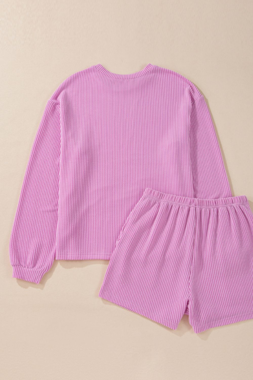 Ribbed fuchsia pink lounge set with long sleeve top and shorts.