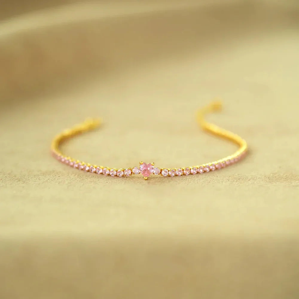 Gold tennis bracelet with pink heart zirconia and pink stones