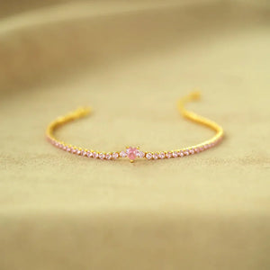 Gold tennis bracelet with pink heart zirconia and pink stones
