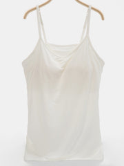 Ivory soft-cup cami with adjustable straps and a draped neckline.
