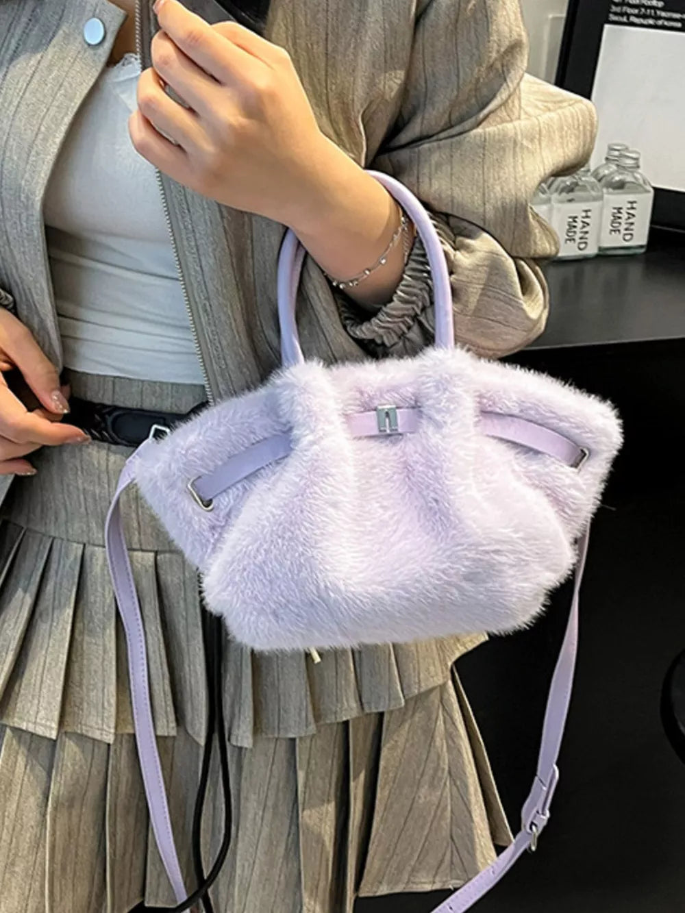 Plush crossbody bag in purple with a chic buckle detail and a detachable strap.