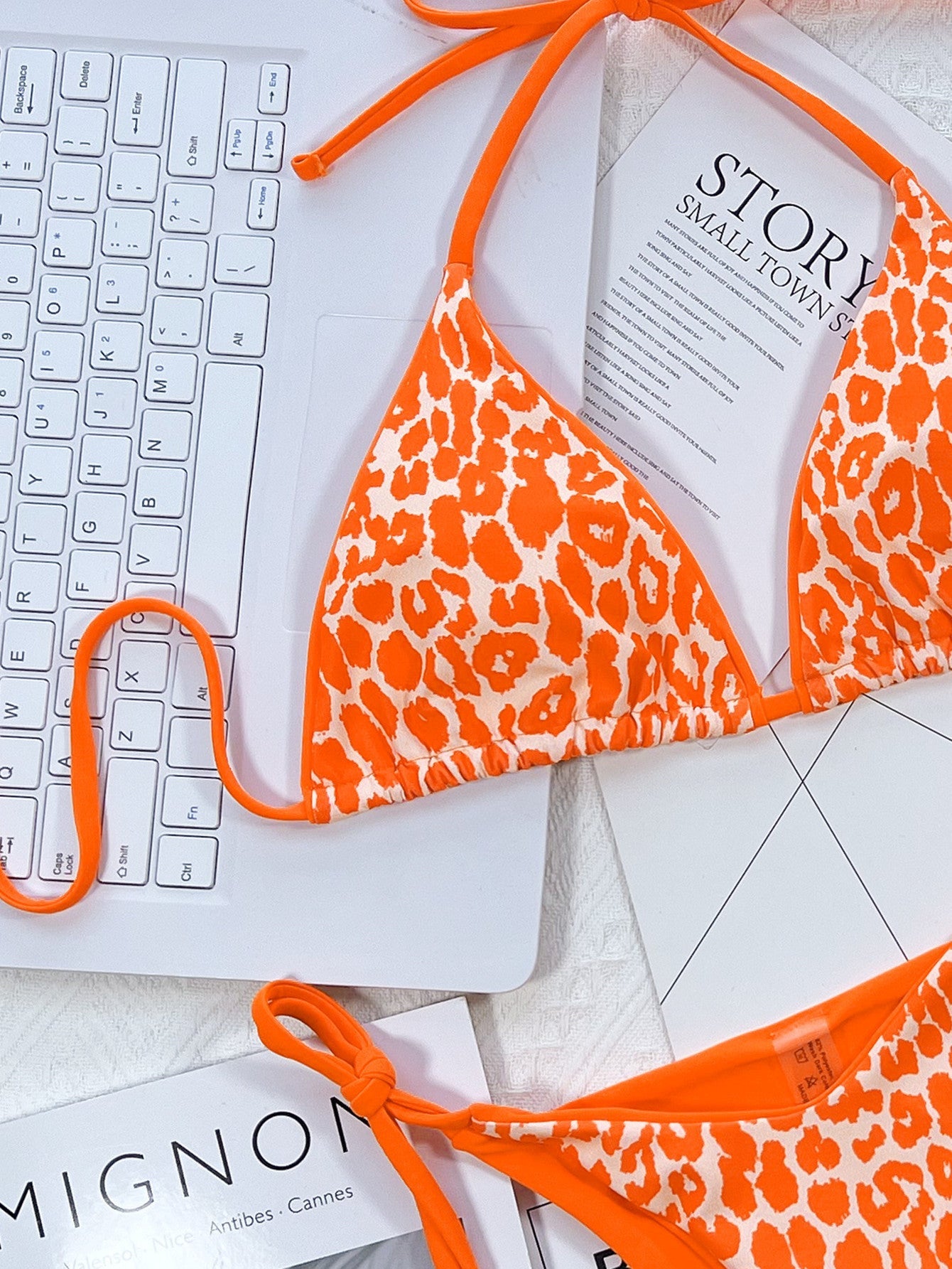 Tangerine leopard print tie-side bikini set with adjustable straps.