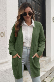 Army green cable knit longline cardigan with pockets and ribbed cuffs.