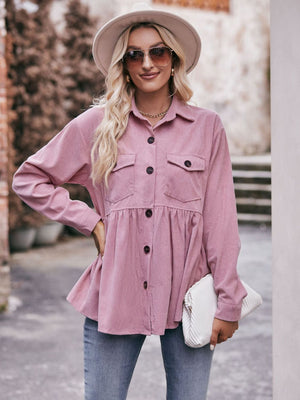 Pink corduroy peplum shirt jacket with button front, chest pockets, and flared hem.