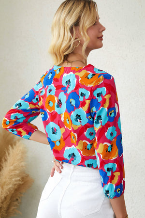 Painterly floral v-neck blouse in hot pink with 3/4 sleeves.