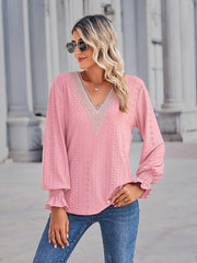 Blush pink eyelet blouse with lace trim V-neck and smocked ruffled cuffs.