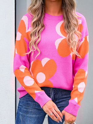 Oversized knit sweater in fuchsia pink with oversized floral pattern in orange and ivory, crew neck, long sleeves.