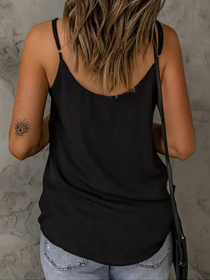 Black cami with V-neck and adjustable straps, paired with jeans.