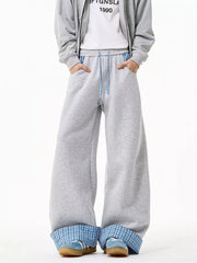Gray wide-leg sweatpants with drawstring and blue plaid cuffs.