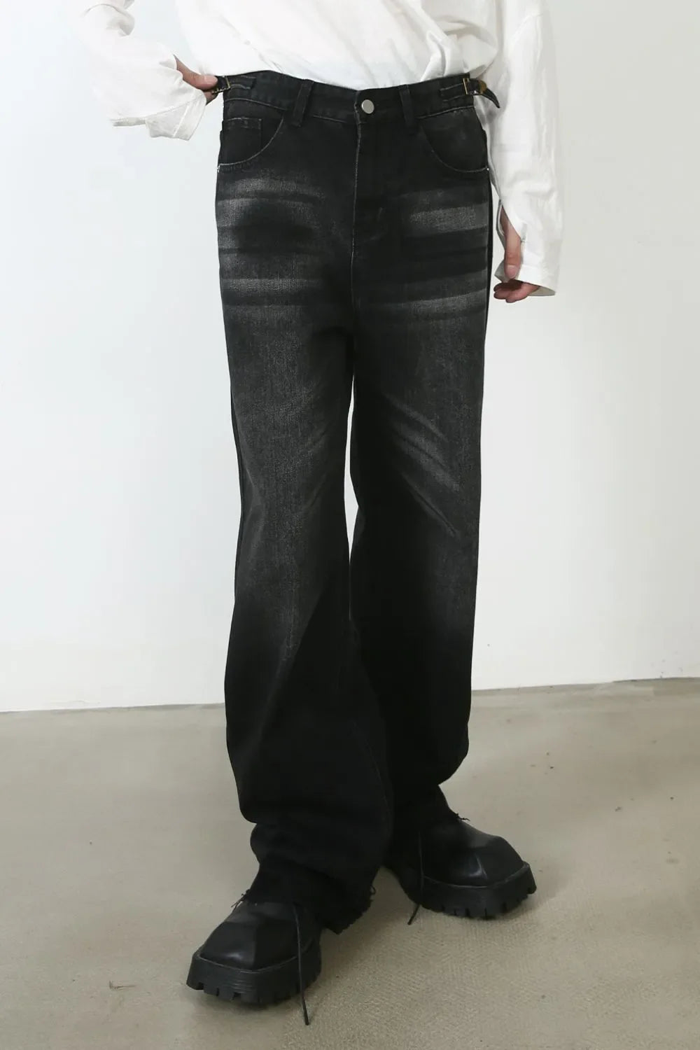 Dark wash denim barrel leg jeans with cat's whisker detailing and a relaxed fit.
