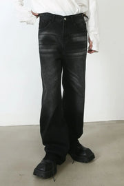 Dark wash denim barrel leg jeans with cat's whisker detailing and a relaxed fit.