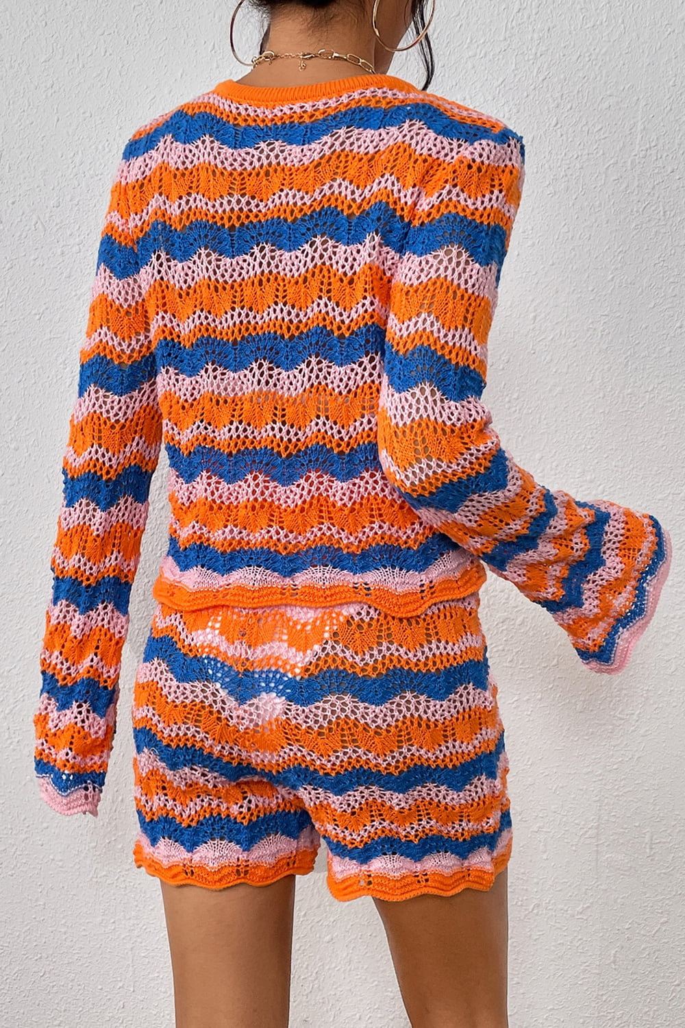 Crochet flare set with chevron stripes in orange, blue, and pink. Bell sleeves and shorts with scalloped trim.