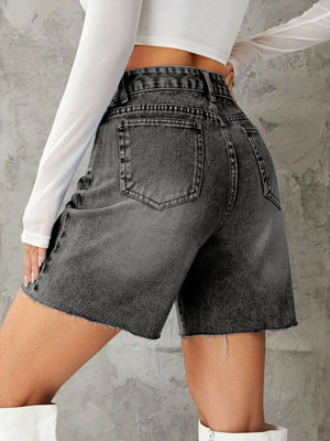 High-waisted denim bermuda shorts in dark gray with frayed hem and button closure.