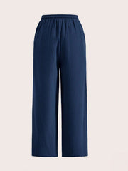 Navy linen wide-leg drawstring trousers with elastic waistband and textured fabric.