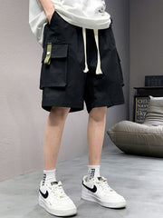 Men's black lightweight cargo shorts with drawstring and green tab detail.