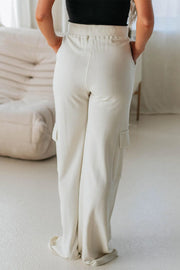 Ivory wide leg cargo pants with side pockets and a relaxed fit.