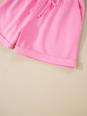 Pink cotton drawstring shorts with cuffed hems