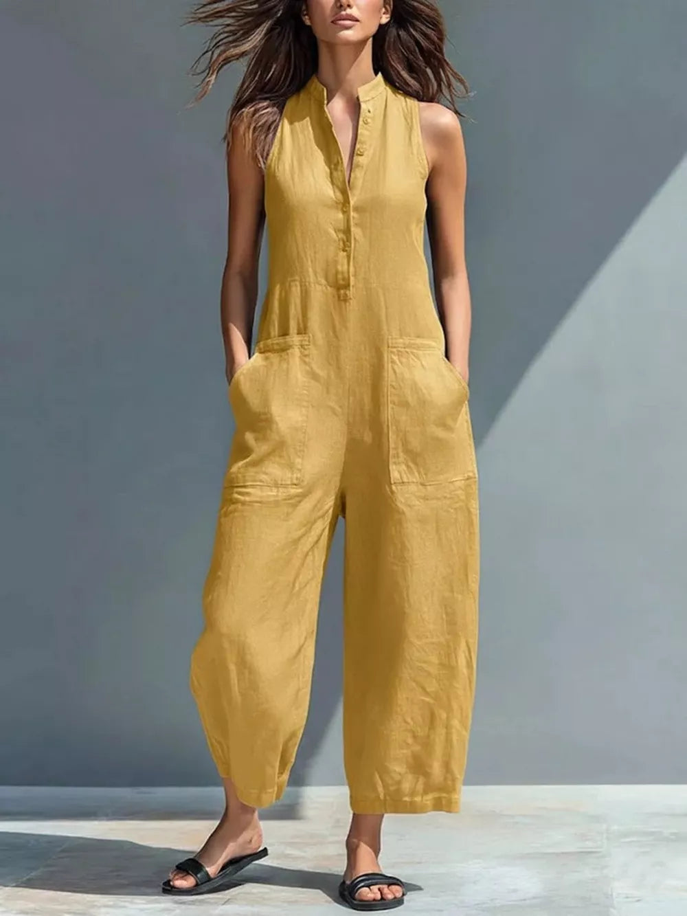 Yellow button-down sleeveless romper with pockets and wide legs
