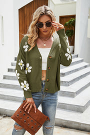 Moss green acrylic knit cardigan with white daisy print, V-neck, button front and long sleeves.