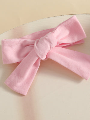 Pink baby headband with a knotted bow detail