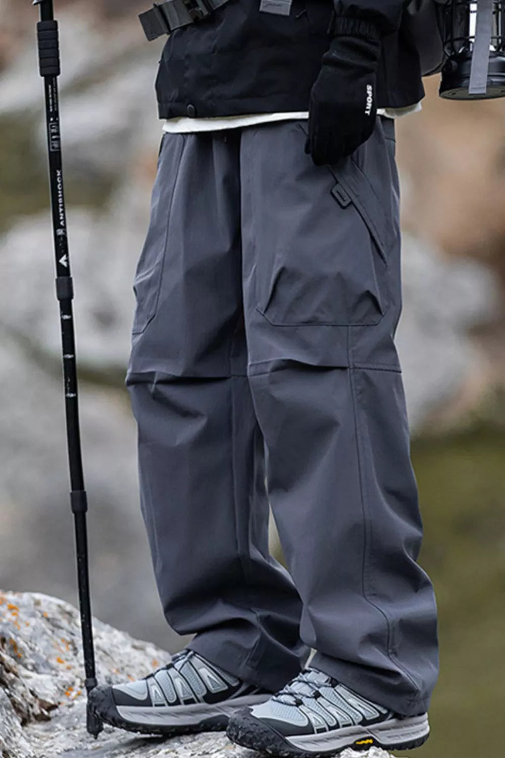 Men's grey cargo pants with multiple pockets and a relaxed fit.