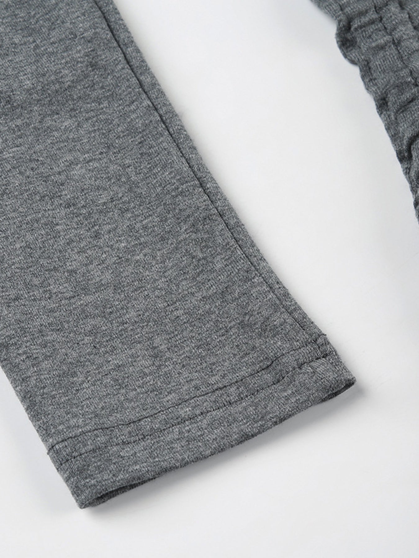 Grey ruched bodycon mini dress sleeve detail with ribbed texture and drawstring.