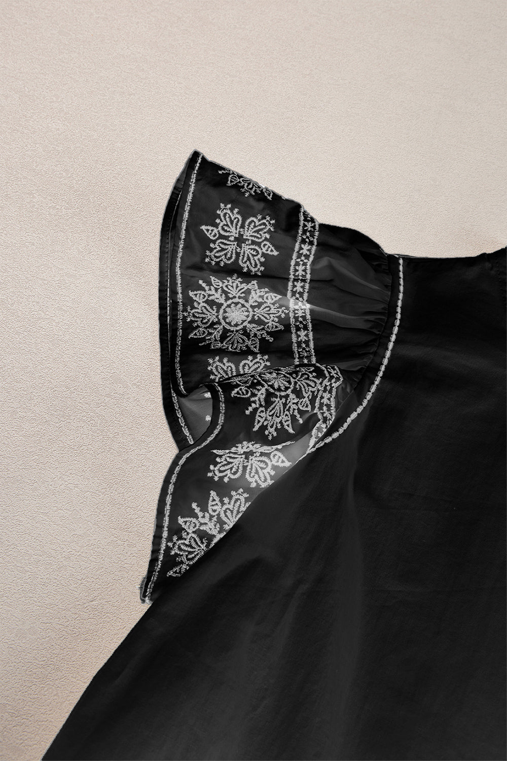 Black embroidered sheer sleeve blouse with ruffle neckline detail.